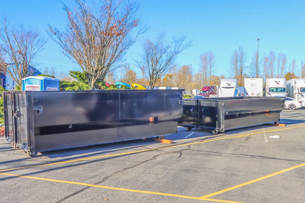 Professional dumpster rental service with roll-off container on residential driveway in Olivehurst